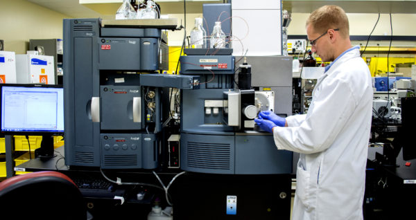 Research scientist monitoring lab equipment